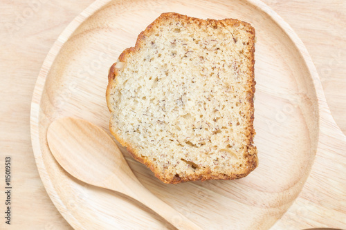 Sweet cake in wooden plate with spoon