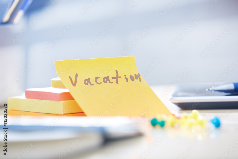 Vacation text on adhesive note Vacation text on adhesive note