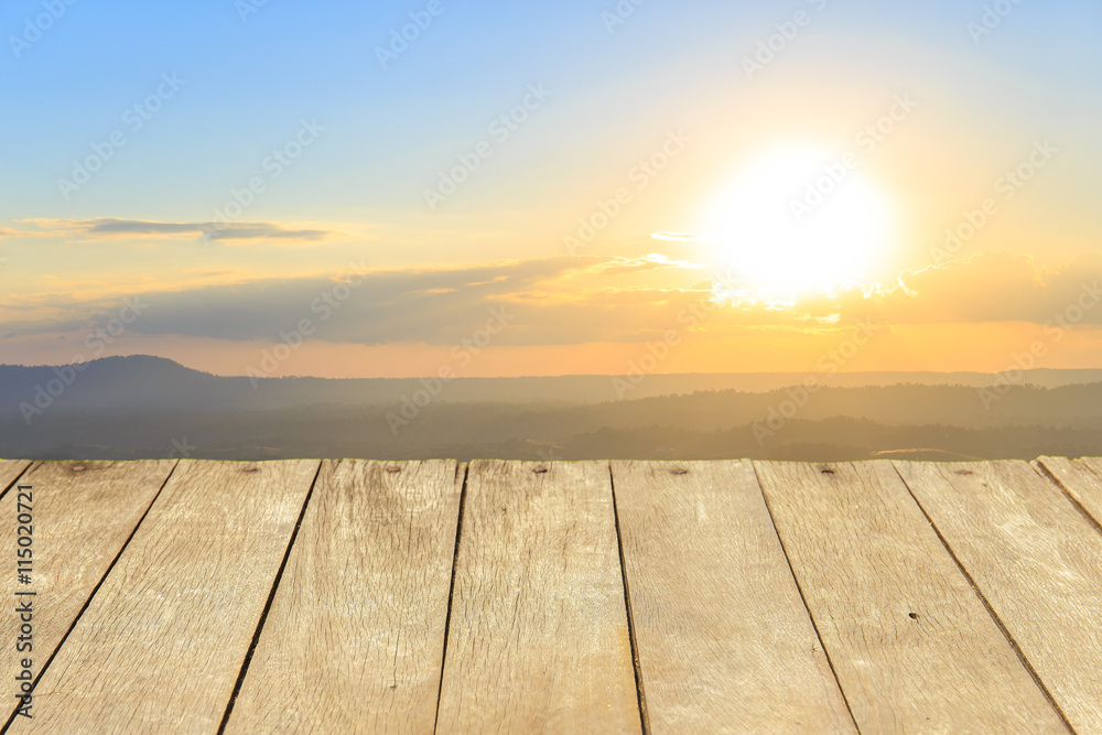 Empty wooden table or plank with Sunset in mountains on background for product display.
