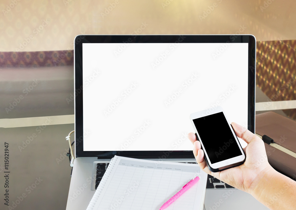 hand with mobile phone or smartphone and blank screen laptop hand with mobile phone or smartphone and blank screen laptop