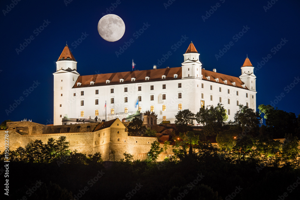 Full moon and illuminated Bratislava castle at night, Slovakia