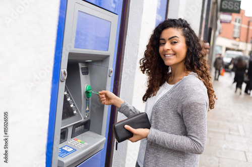 young woman at the cash machine photo