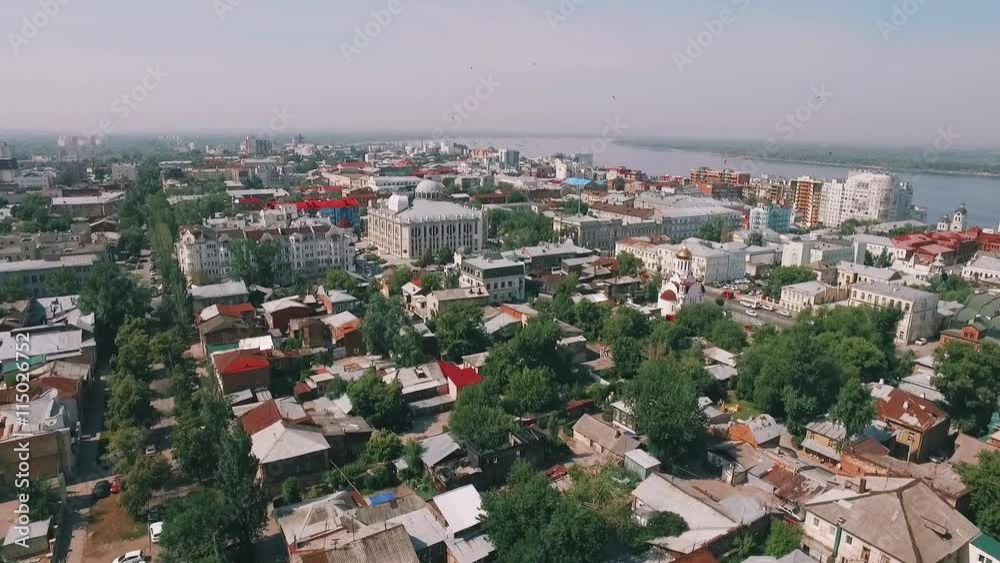 camera is flying over cityscape from quiet yards to building with round dome