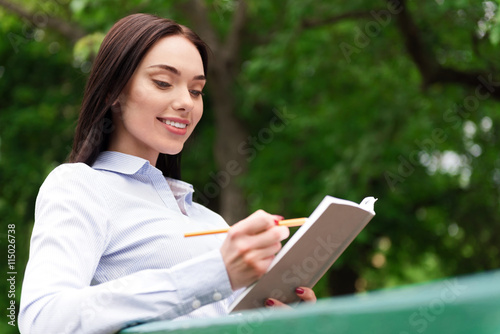 Positive woman making notes