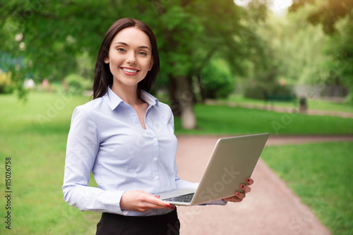 Positive woman holding laptop © zinkevych