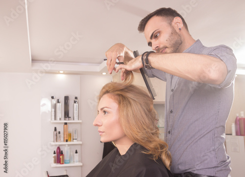 side view hairdresser cutting woman hair scissors