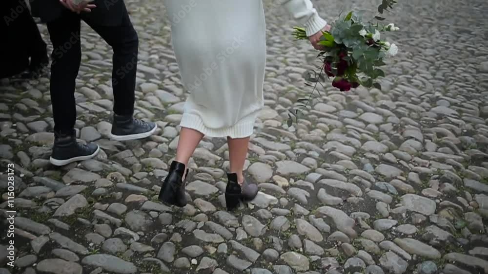 Couple walking on the pavement legs view. Couple walking on the pavement legs view.