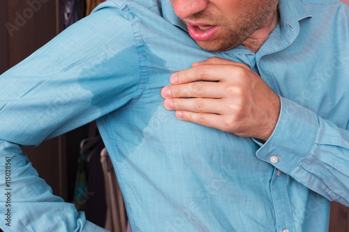 Fotografie Sweaty spot on the shirt because of the heat, worries and diffid