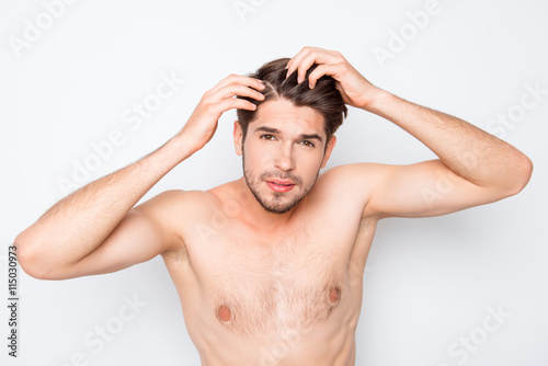 Fit healthy young man expertising his hair and looking for furfu