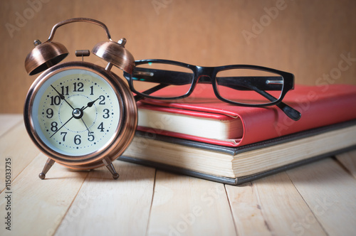 Retro alarm clock and book.