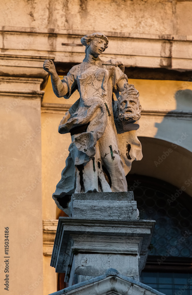 17th century statue of Judith with the head of Holofernes on the dome of the Santa Maria della Salute church in the Dorsoduro quarter of Venice, Italy