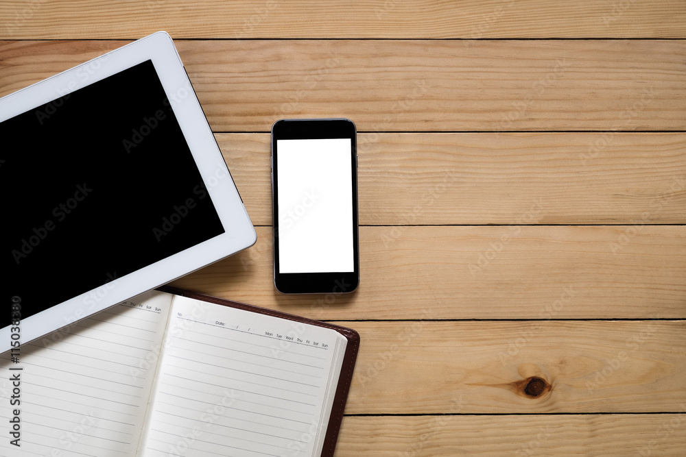 Office stuff with blank screen tablet, blank screen smartphone and leather notebook top view with workspace.Flat lay image Office stuff with blank screen tablet, blank screen smartphone and leather notebook top view with workspace.Flat lay image