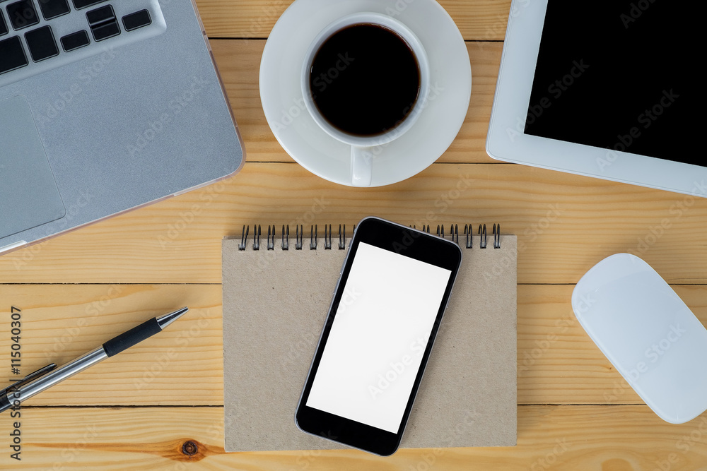 Office stuff with blank screen smartphone, laptop, tablet, mouse, pen, leather notebook and cup of coffee. Top view gadgets. Office stuff with blank screen smartphone, laptop, tablet, mouse, pen, leather notebook and cup of coffee. Top view gadgets.