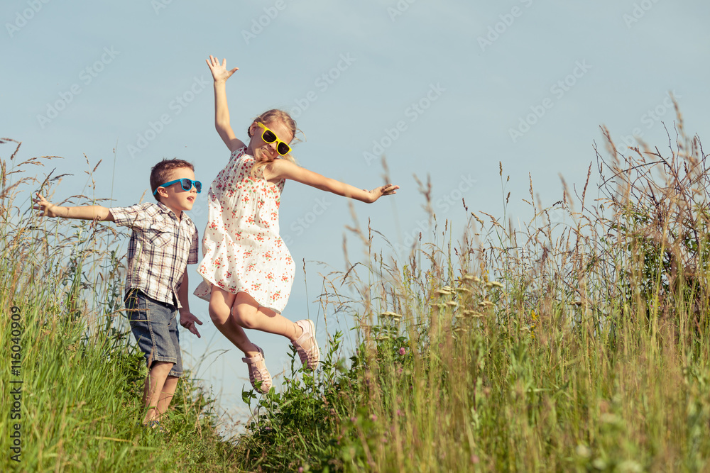 Happy children playing on the field at the day time. Happy children playing on the field at the day time.