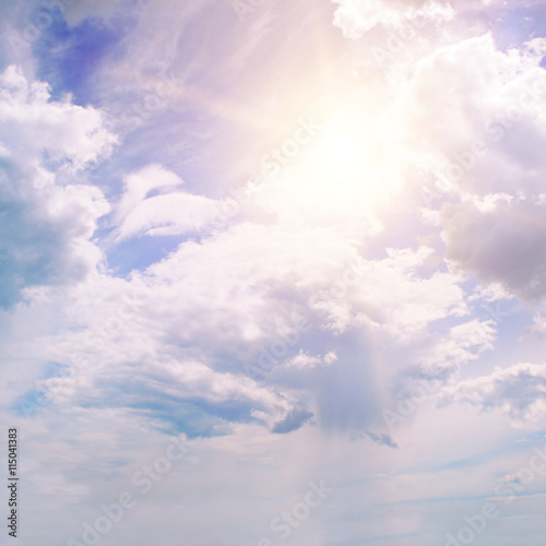 sun on blue sky with white clouds