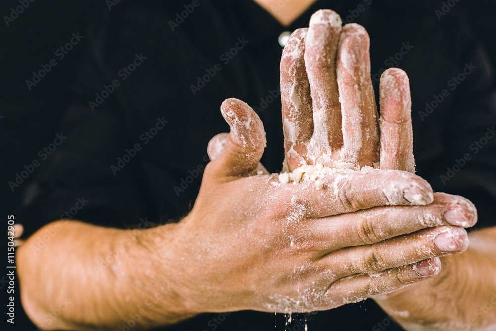 Fototapeta premium adult man hands work with flour, dark photo