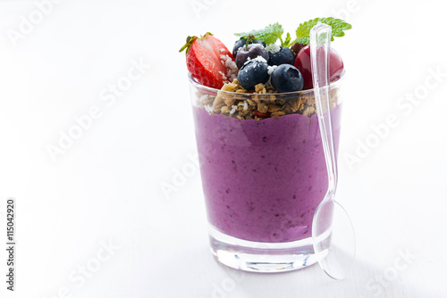 blueberry yogurt with granola on a white table