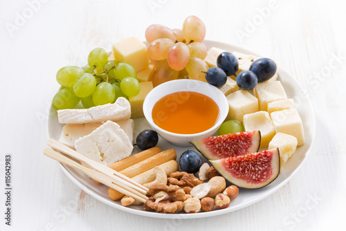 plate of cheese, fruit and snacks