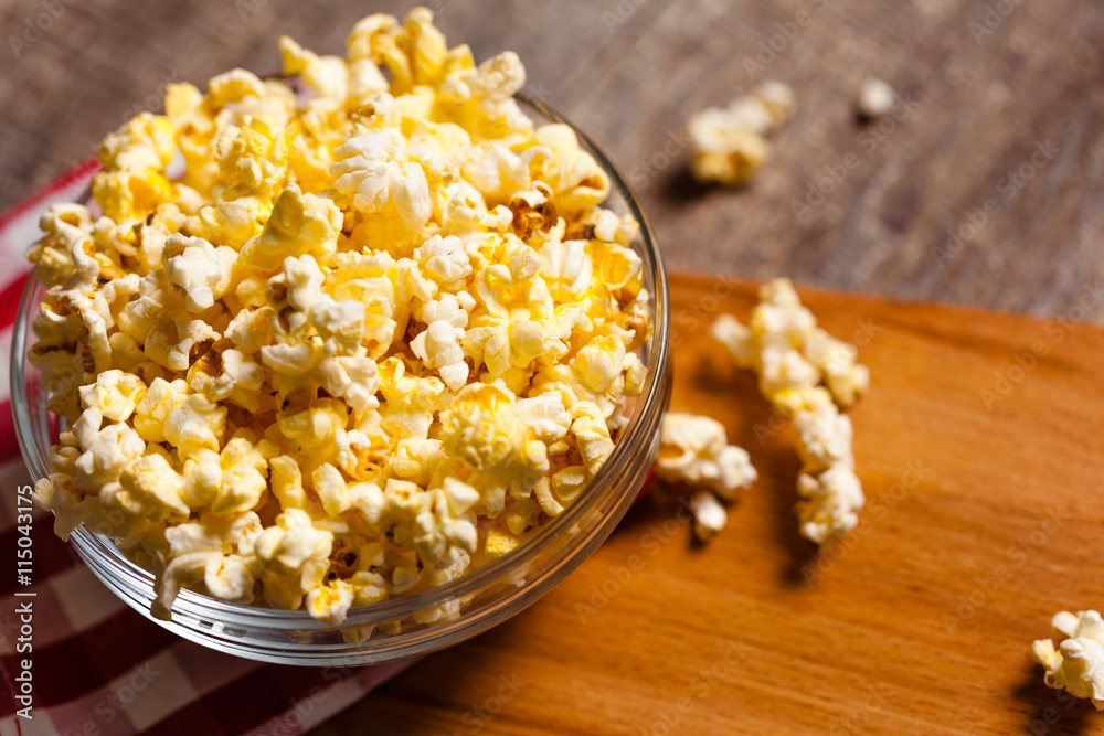 A bowl of popcorn on tablecloth A bowl of popcorn on tablecloth