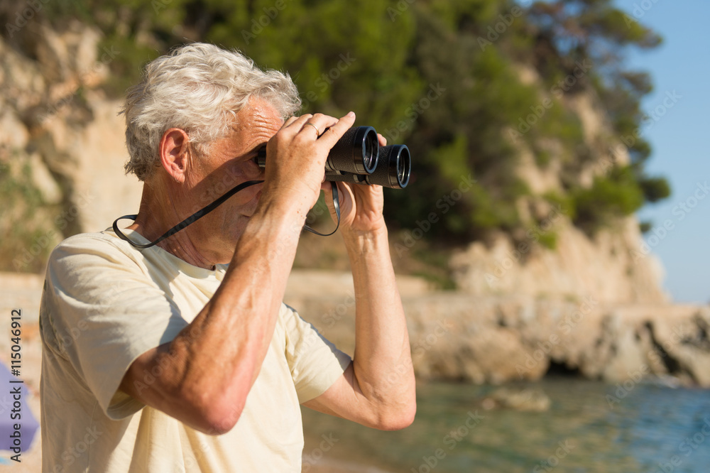 Senior man with spy glasses