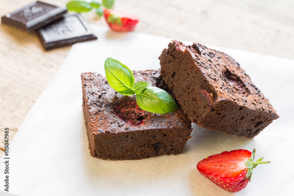 Chocolate brownie cake decorated with strawberries. Selective fo Chocolate brownie cake decorated with strawberries. Selective fo