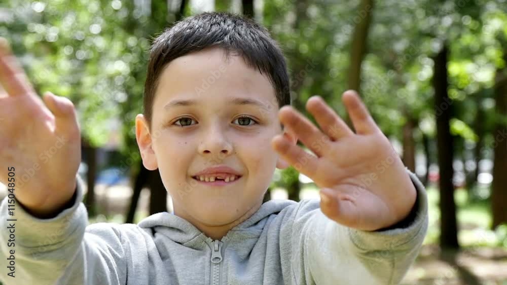 handsome boy waves his hands in the park, slow motion handsome boy waves his hands in the park, slow motion