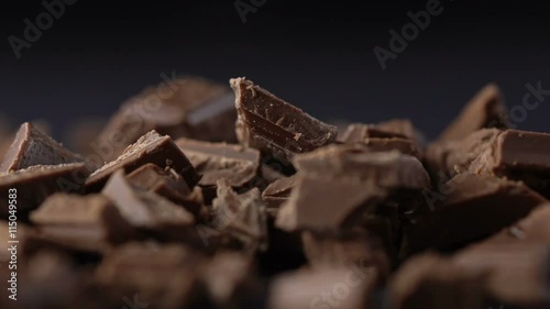 Falling pieces of chopped chocolate with cocoa