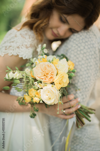Perfect wedding couple holding luxury bouquet of flowers
