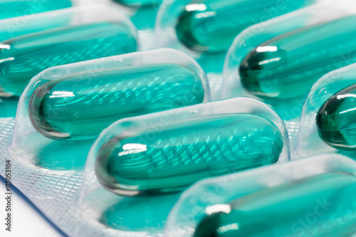 green soft gel capsules pills in blister pack photo