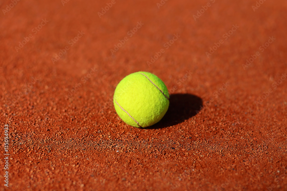 tennis court with tennis ball and antuka background.