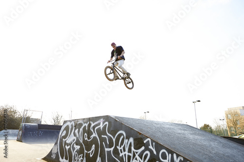 Young man jumping on bmx bicycle