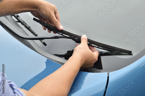 man hand picking up windscreen wiper