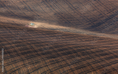Tractor plowing a stripped ...