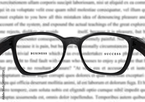  Glasses with blurred vocabulary, and focus on business and success word, concept of success