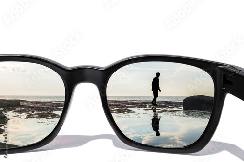 Sunglasses with silhouette man with reflection on water, isolated on white background