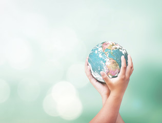 Hands holding earth globe on green bokeh background for environmental conservation concept