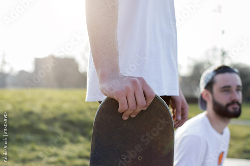 Young man holding skateboard