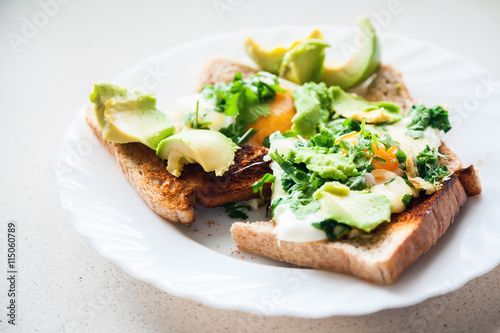 two eggs on toasts with avocado