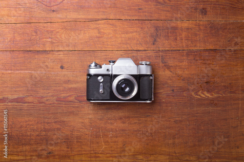 Retro camera on wood table background