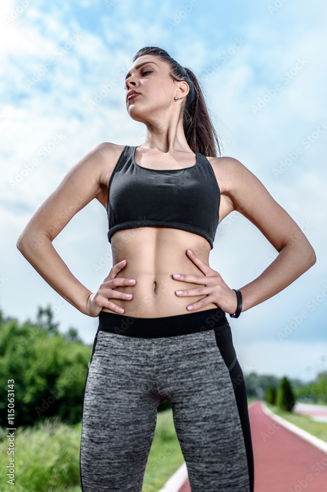 Young Active Girl Standing on the Racing Track Young Active Girl Standing on the Racing Track