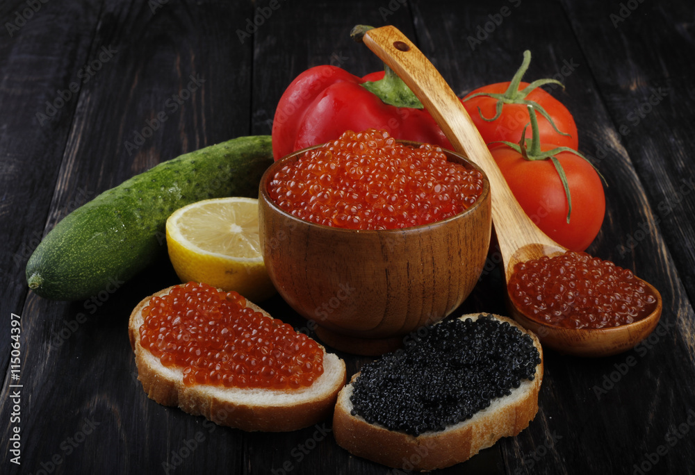 red and black caviar with bread on wooden background 