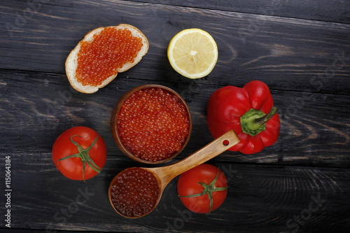 red and black caviar with bread on wooden background 