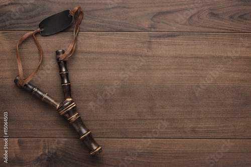 Stampa su Tela handmade wooden slingshot on the brown table