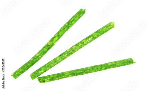 Green beef hide dyed dog snacks isolated on a white background.