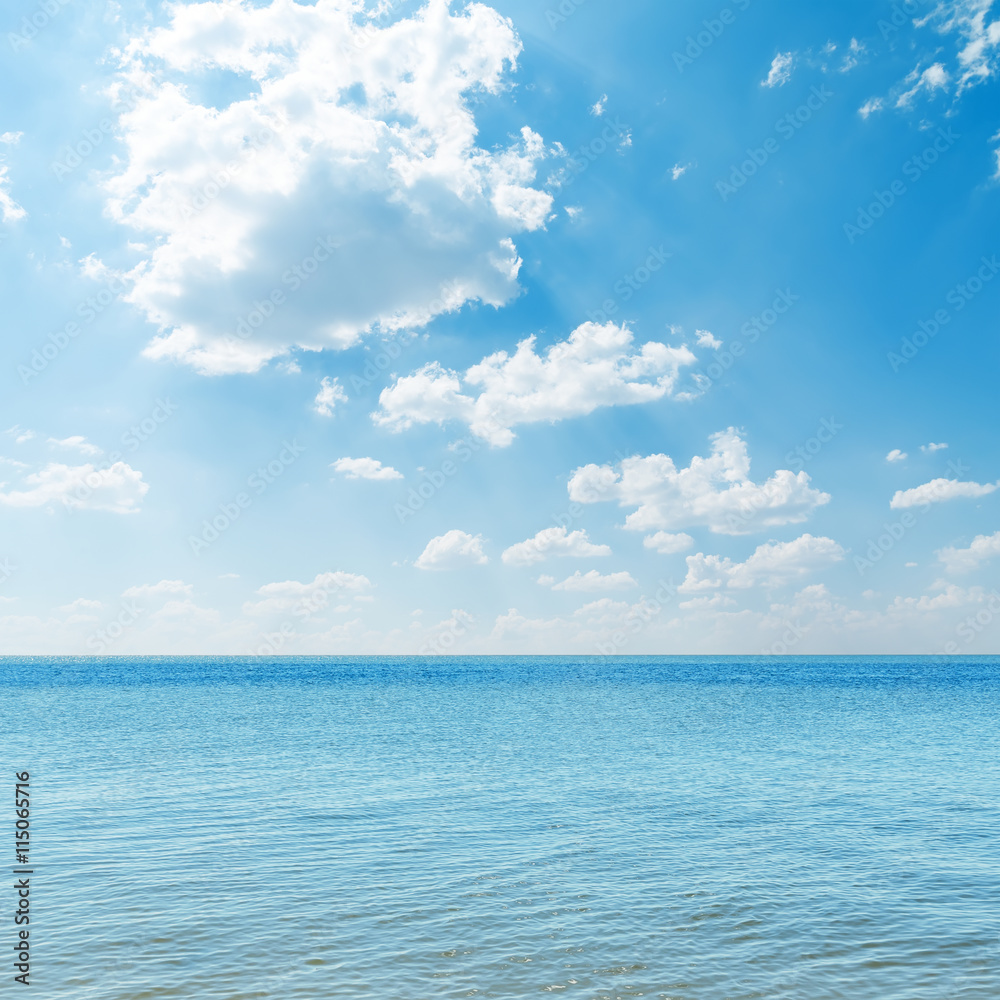 Obraz premium blue sea and clouds over it