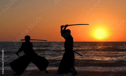 Men silhouettes practicing Aikido photo