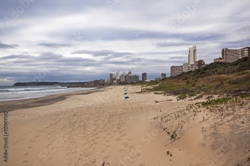 Empty Beach Sand Dunes and Vegetation Against  City Skyline