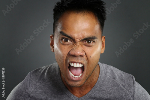 Young asian man screaming