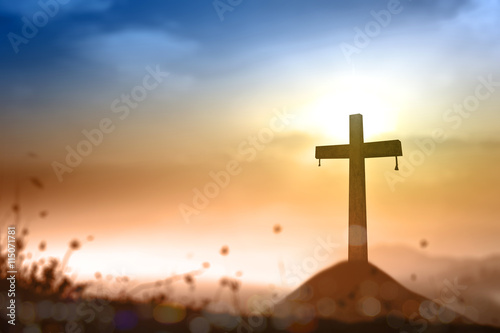Ascension day concept: Cross on sunset background photo