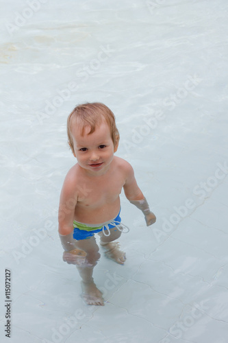 Little boy plays in the pool